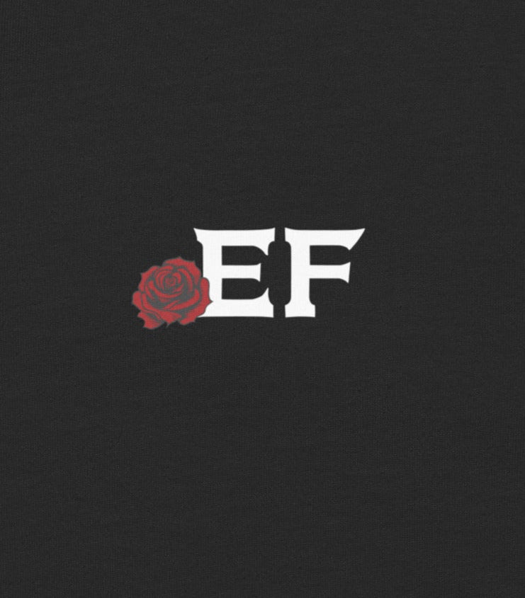 Black shirt with a small red rose and 'EF' logo on a dark background